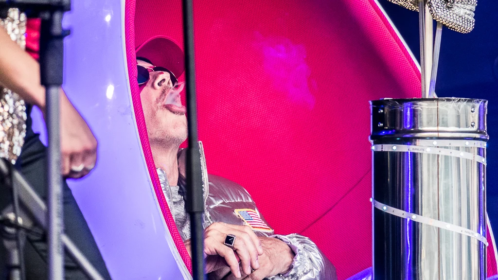 I smoke in my armchair, facing the audience.
